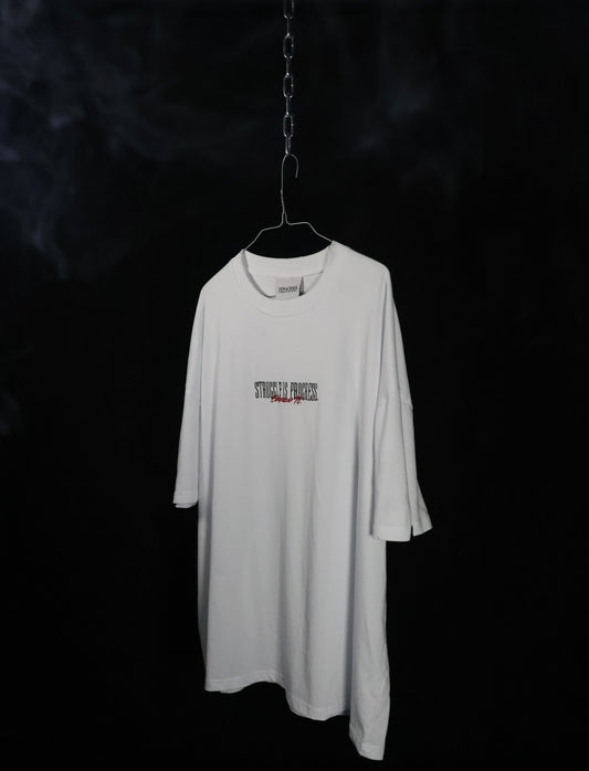 Oversized white "Struggle is progress" tee